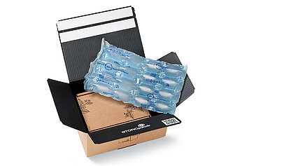 
			Open cardboard box with protective air cushions